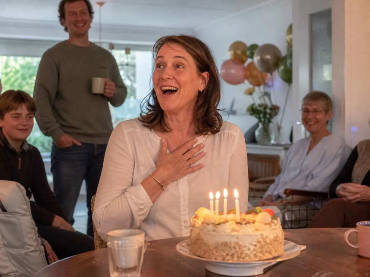 Birthday woman reacting with joy to her personalized song