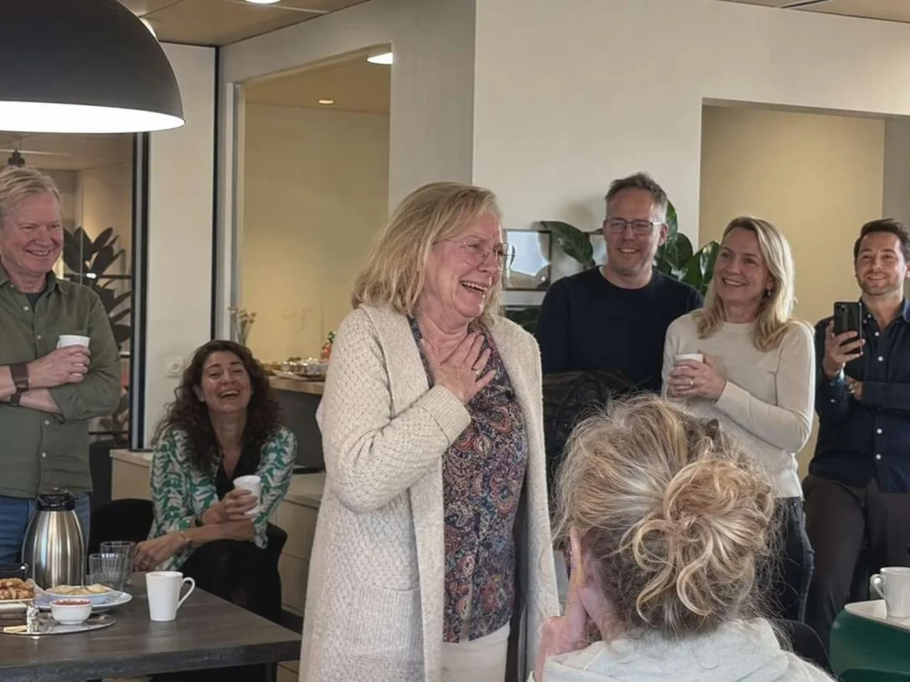Colleague reacting emotionally to her personalized retirement song