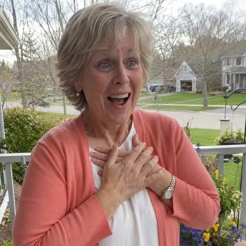 Older woman reacting with joy on a front porch