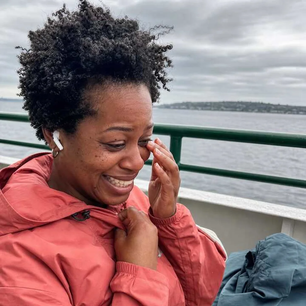 Woman laughing while wiping away a happy tear