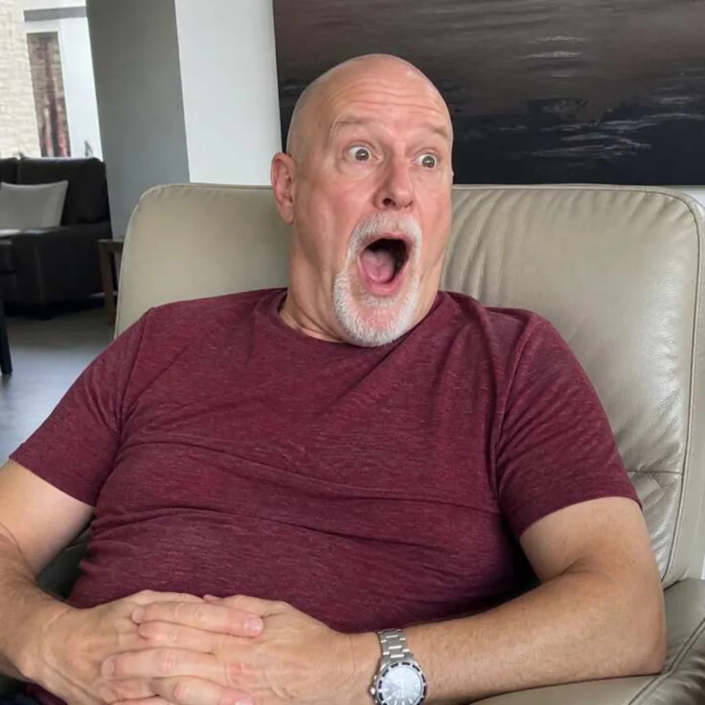 Bald man looking delighted and shocked
