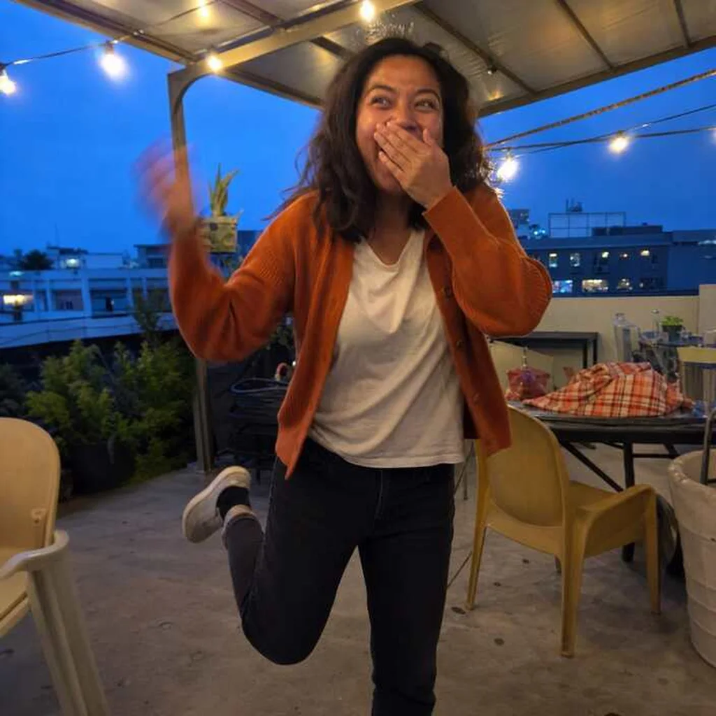Young woman jumping with delighted surprise